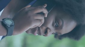 Animation of media icons over african american woman talking on smartphone. Technology, social media and digital interface concept digitally generated video. - Powered by Shutterstock - Get 15% off with code: PIKWIZARD15