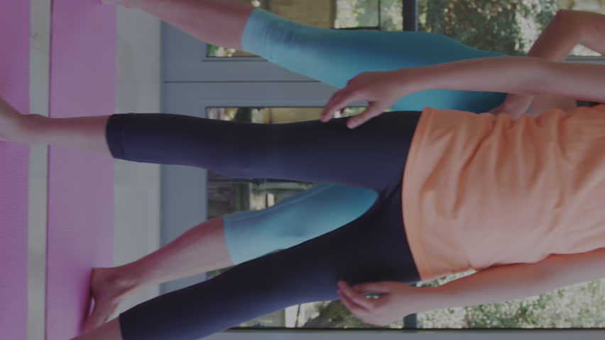 Animation of horoscope zodiac libra star sign over caucasian mum and daughter practicing yoga. Star signs, horoscope and yoga meditation concept digitally generated video.