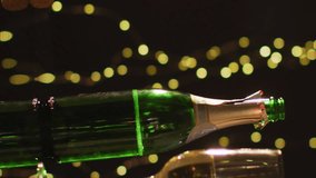 Animation new year greetings over champagne bottle and glasses. New year's eve, festivity, celebration and tradition concept digitally generated video. - Powered by Shutterstock - Get 15% off with code: PIKWIZARD15