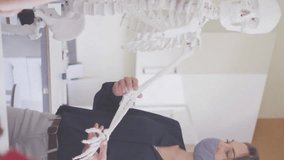 Animation of school icons over diverse schoolchildren and teacher wearing face masks. school, education and study during covid 19 pandemic concept digitally generated video. - Powered by Shutterstock - Get 15% off with code: PIKWIZARD15