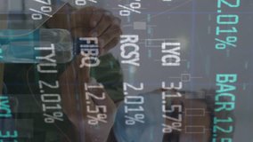 Animation of stock market data processing over man using hand sanitizer at office. Global economy and business technology concept - Powered by Shutterstock - Get 15% off with code: PIKWIZARD15