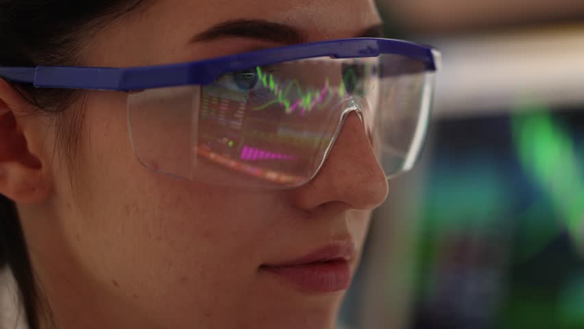 Young woman wearing glasses with reflection on blurred background, closeup