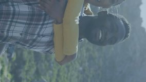 Animation of american flag over smiling diverse couple embracing in mountains. patriotism and celebration concept digitally generated video. - Powered by Shutterstock - Get 15% off with code: PIKWIZARD15