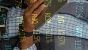 Animation of stock market over man working in warehouse. global shipping, delivery and connections concept digitally generated video. - Powered by Shutterstock - Get 15% off with code: PIKWIZARD15