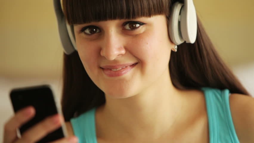 Young woman laughing and listening music
