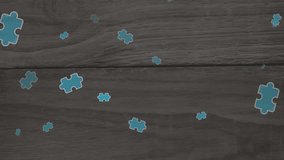 Animations of colorful puzzle pieces over black wooden background. Autism awareness concept digital generated video. - Powered by Shutterstock - Get 15% off with code: PIKWIZARD15