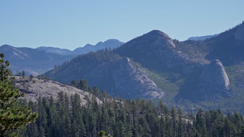 Pan left glides across Yosemite’s remote High Sierra back-country, revealing glacier-smoothed granite slabs, rounded domes, and jagged crest lines.