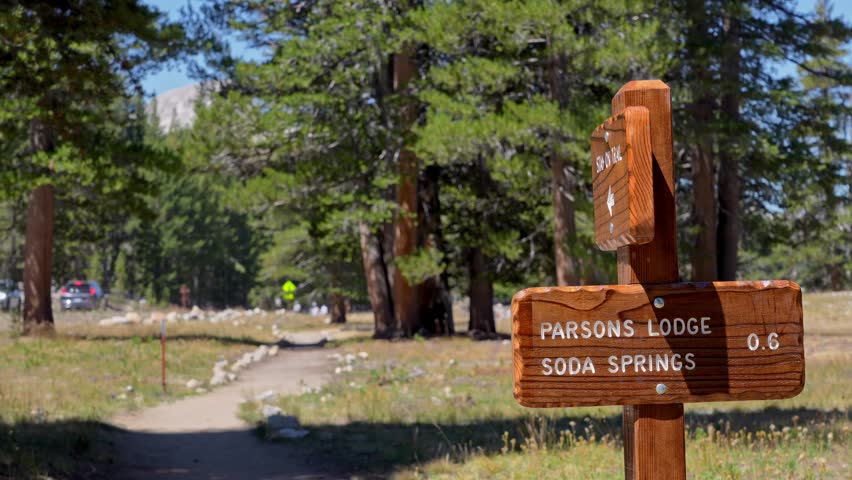 4K close-up captures a weather-worn wooden trail signpost for Soda Springs in Tuolumne Meadows, Yosemite National Park. Perfect B-roll for travel, hiking, nature, or outdoor-adventure projects.