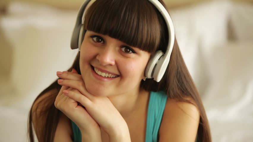 Young woman listening music and laughing
 | Shutterstock HD Video #3853142