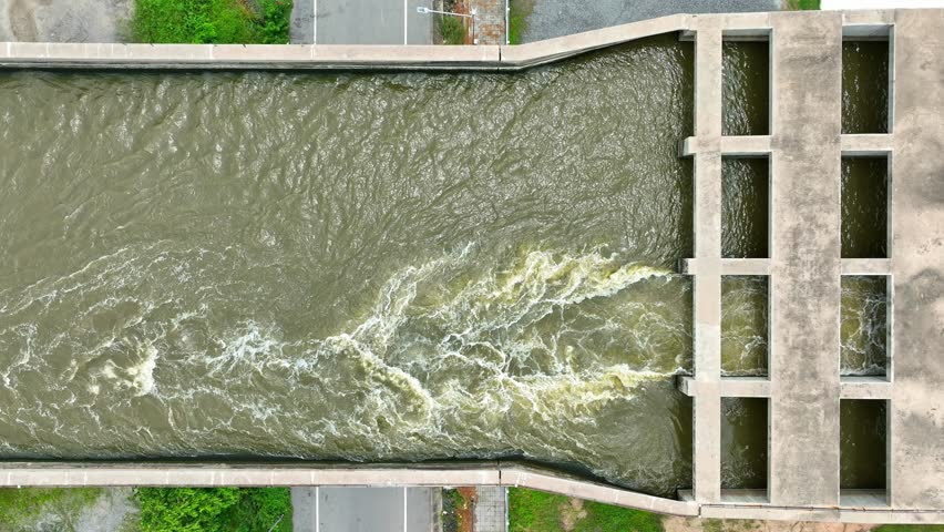 Efficiently moving water from inland to the sea, the pumping station and Transfer Bridge work together to manage drainage and prevent urban flooding. Thailand. Aerial view. 
