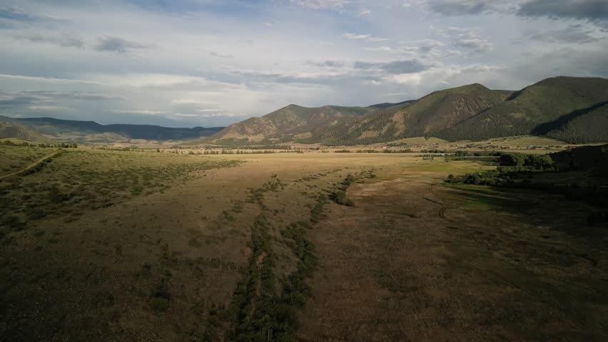 Aerial over rural hills in Creede Colorado at sunset in San Juan mountains