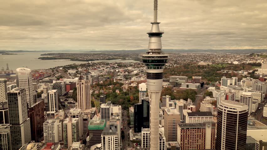 Sky Tower, Auckland cityscape and central business district, North Island, New Zealand. Aerial drone orbiting