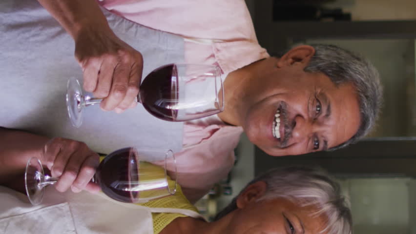 Animation of digital social media people icons over senior couple drinking wine using smartphone. global social medial, connection and communication concept digitally generated video.