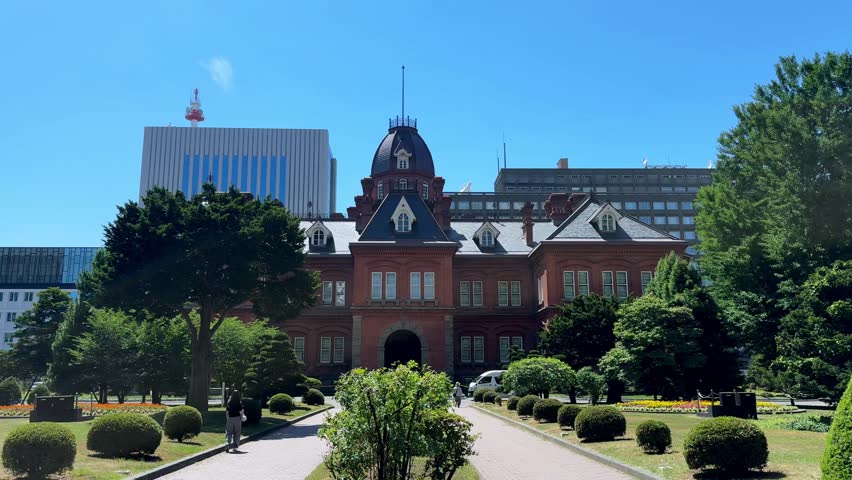 Historical architecture in sunny Sapporo with lush greenery around