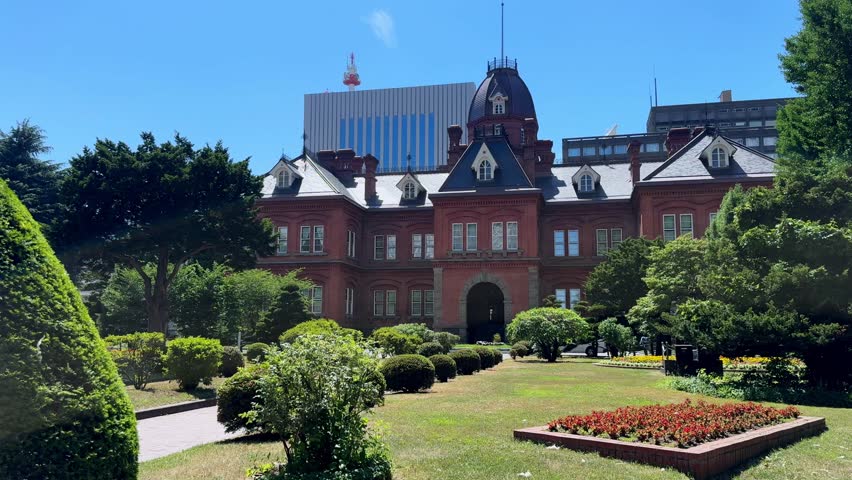 Historic brick building in sunny Sapporo park garden setting