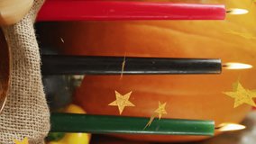 Animation of golden stars over kwanzaa candles and pumpkins. Kwanzaa festivity, celebration and tradition concept digitally generated video. - Powered by Shutterstock - Get 15% off with code: PIKWIZARD15