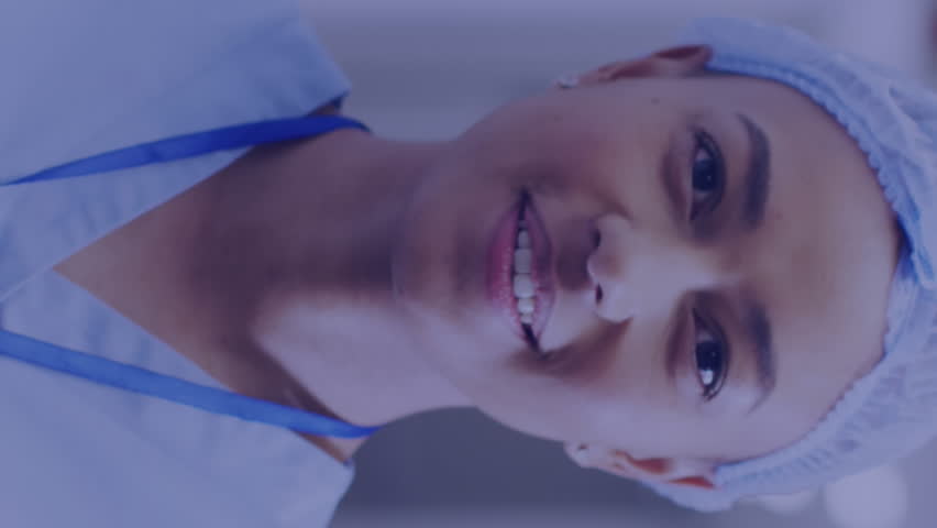 Animation of medical data processing over smiling female doctor in hospital. Global medicine, healthcare, digital interface, computing and data processing concept digitally generated video. - Powered by Shutterstock - Get 15% off with code: PIKWIZARD15