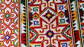 Close-up of traditional Yao Mien textile featuring intricate hand embroidery and colorful tribal patterns. This ethnic needlework reflects the rich cultural heritage and skilled craftsmanship of the Y - Powered by Shutterstock - Get 15% off with code: PIKWIZARD15