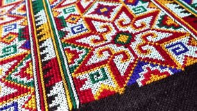 Close-up of traditional Yao Mien textile featuring intricate hand embroidery and colorful tribal patterns. This ethnic needlework reflects the rich cultural heritage and skilled craftsmanship of the Y - Powered by Shutterstock - Get 15% off with code: PIKWIZARD15