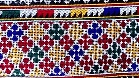 Close-up of traditional Yao Mien textile featuring intricate hand embroidery and colorful tribal patterns. This ethnic needlework reflects the rich cultural heritage and skilled craftsmanship of the Y - Powered by Shutterstock - Get 15% off with code: PIKWIZARD15