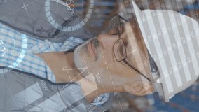 Close up of a distribution warehouse Caucasian worker wearing a hard hat smiling. Digital animation graphs and statistics are seen running in the foreground - Powered by Shutterstock - Get 15% off with code: PIKWIZARD15