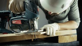 Carpenter Using Jigsaw To Cut Wood Plank.Professional Woodworking Craft. Home Improvement Project. Industrial Power Tool.Manual Labor, Workshop Environment. Construction Worker Safety Carpentry Skills - Powered by Shutterstock - Get 15% off with code: PIKWIZARD15