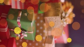 Animation of golden dots stars falling over presents and christmas tree in background. christmas, tradition and celebration concept digitally generated video. - Powered by Shutterstock - Get 15% off with code: PIKWIZARD15