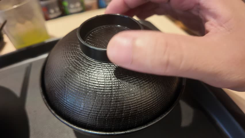 On Sunday July 27th 2025, Chiba Japan, opening a bowl of miso soup at Matsuya, a well known Japanese Fast food chain serving traditional meals like Gyudon and miso soup