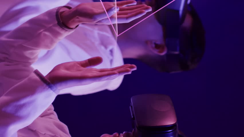 Animation of glowing 3d shapes over asian people using vr headset. Global virtual reality, computing, digital interface and data processing concept digitally generated video. - Powered by Shutterstock - Get 15% off with code: PIKWIZARD15