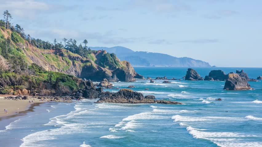 Footage shows Ecola State Park on the Oregon coast, a scenic landscape of steep cliffs, dense forests, and long sandy beaches popular for hiking and nature photography.