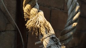 A close-up shot of an old, tangled rope in natural light, showing its texture and wear. The background features rustic wood and stone elements, adding to the old and vintage feel. - Powered by Shutterstock - Get 15% off with code: PIKWIZARD15