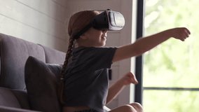 Amazingly surprised Caucasian girl child schoolgirl is playing an online video game in a 3D world using virtual reality. Explore cyberspace with VR glasses. Virtual boxing, wrestling - Powered by Shutterstock - Get 15% off with code: PIKWIZARD15