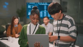 Focused African American woman leader and programmer in modern diverse office showing professional collaboration with her male colleague. Confident teamwork analyzing code - Powered by Shutterstock - Get 15% off with code: PIKWIZARD15