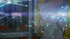 Woman tapping tablet and animating network overlay while reviewing sticky note ideas at office. Collaboration, innovation, teamwork, digital, communication, brainstorming, modern - Powered by Shutterstock - Get 15% off with code: PIKWIZARD15