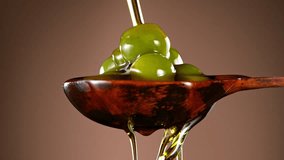 Super Slow Motion of Green Olives in Wooden Spoon with Pouring Oil . Filmed on High Speed Cinematic Camera at 1000 FPS - Powered by Shutterstock - Get 15% off with code: PIKWIZARD15