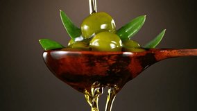 Super Slow Motion of Green Olives in Wooden Spoon with Pouring Oil . Filmed on High Speed Cinematic Camera at 1000 FPS - Powered by Shutterstock - Get 15% off with code: PIKWIZARD15