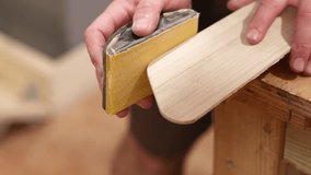 Carpenter sanding wooden plank with sandpaper - Powered by Shutterstock - Get 15% off with code: PIKWIZARD15