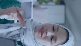 Animation of network of connections over woman in hijab using tablet. Global data processing, computing and digital interface concept digitally generated video. - Powered by Shutterstock - Get 15% off with code: PIKWIZARD15