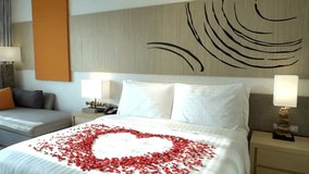 A romantic hotel bedroom decorated with rose petals in a heart shape - Powered by Shutterstock - Get 15% off with code: PIKWIZARD15