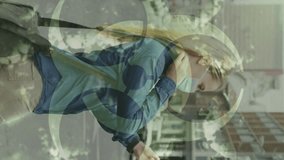 Animation of virus cells and biohazard sign over caucasian woman wearing face mask. global covid 19 pandemic and health concept digitally generated video. - Powered by Shutterstock - Get 15% off with code: PIKWIZARD15