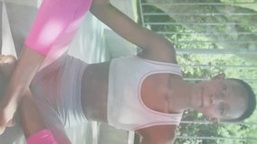 Animation of leaves over african american woman practicing yoga and meditating. world meditation day and celebration concept digitally generated video. - Powered by Shutterstock - Get 15% off with code: PIKWIZARD15