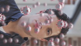 Animation of covid 19 cells floating over portrait of caucasian man putting face mask on in office. Healthcare and protection during coronavirus covid 19 pandemic, digitally generated video. - Powered by Shutterstock - Get 15% off with code: PIKWIZARD15