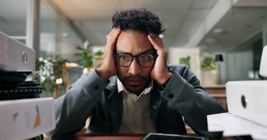 Pile, stress and business man at desk with documents for deadline, tasks and work load. Thinking, office and overwhelmed person with paperwork, files and report for burnout, frustrated and overworked