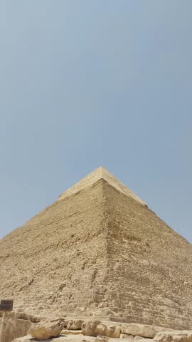 Full HD 1080 Vertical video footage, Archeology reels, Seven Wonders of the World. Great Pyramids of Giza, tilt down shot of khephren pyramid, selective focus with shallow depth of field.  Cairo Egypt