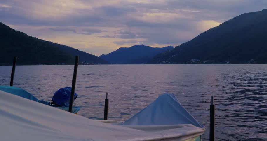 Lake shore boats sunset dusk Como Switzerland mountains ducks water sun reflections
