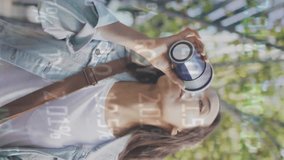 Animation of stock market data processing over asian woman using smartphone on the street. Global economy and business technology concept - Powered by Shutterstock - Get 15% off with code: PIKWIZARD15