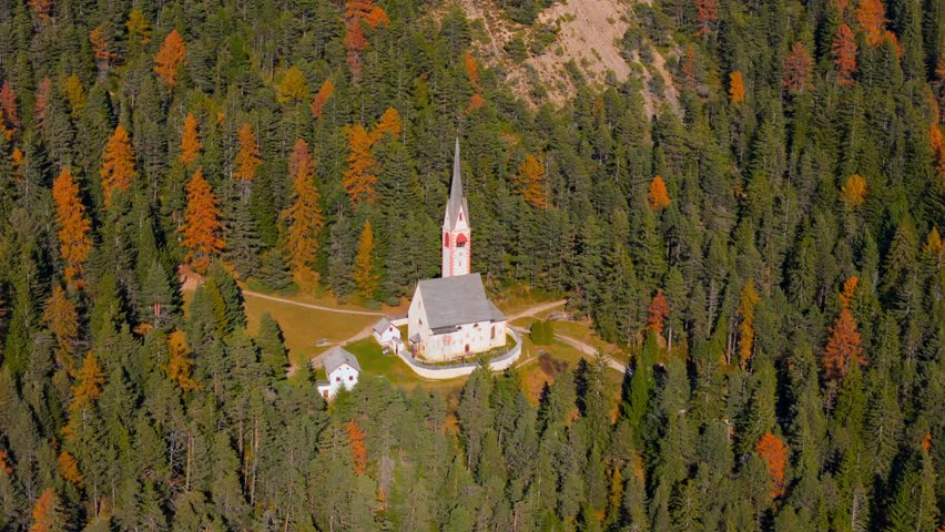 Church of St. Jacob with mountains in the background. Italy
