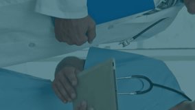 Animation of data processing over diverse male doctor and health worker discussing at hospital. Global economy and medical healthcare technology concept - Powered by Shutterstock - Get 15% off with code: PIKWIZARD15