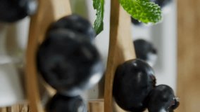 Animation of organic produce vegan locally grown text over blueberries. Food and ecology concept digitally generated video. - Powered by Shutterstock - Get 15% off with code: PIKWIZARD15