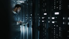 It Engineer With Beard Works on a Laptop While Inspecting Server Racks in Data Center. Advanced Digital Infrastructure, Illuminated Servers, and Secure Cloud Computing and Big Data Management. - Powered by Shutterstock - Get 15% off with code: PIKWIZARD15